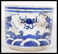 A 19th Century Chinese ceramic brush pot, blue & white glaze with decoration of two dragons