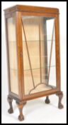 A mid 20th Century mahogany Queen Anne revival upright display cabinet bookcase raised on ball and