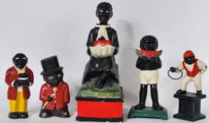 A collection of four vintage Negro style cast metal money boxes, all with hand painted finish
