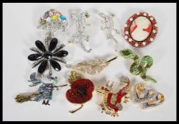 A collection of vintage crystal encrusted costume brooches by Adrian Buckley to include a Chinese