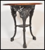 A 20th Century cast metal Victorian style Britannia  circular pub table with mahogany circular