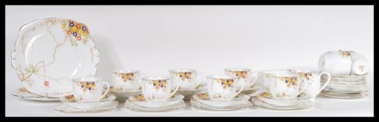 An early 20th Century Art Deco bone China tea service.The transfer printed and hand painted