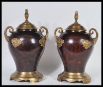 A pair of 20th Century bronze and ormolu urn vases having bulbous bodies with scrolled gilt