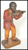 A decorative resin cast and painted figure of a negro American  jazz musician with violin being
