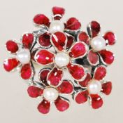 A sterling silver freshwater pearl and enamel set ring having floral red enamel clusters with