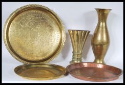 A collection of 20th Century brass wares to include two brass trays with engraved decoration, a