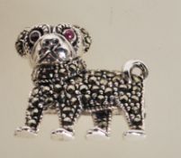 A sterling silver figural brooch in the form of a dog having a marcasite decorated body with red