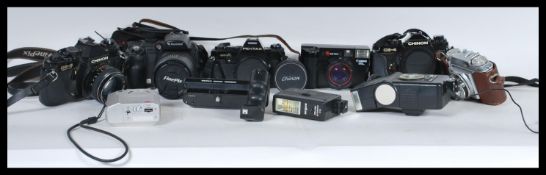 A collection of vintage film and digital cameras and camera equipment to include a Pentax super A