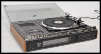 A retro 20th Century ITT 5042 Stereo Music Centre, smoked perspex lift up lid with a fitted BSR