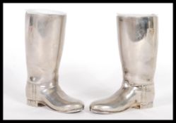 A pair of 20th Century silver plated drinks measures in the form of riding boots having raised