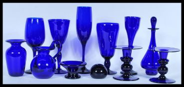 A collection of Bristol Blue glass to include paperweight, wine glasses, goblets, champagne flutes