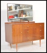 A vintage mid 20th Century teak wood dressing table having a configuration of three graduating