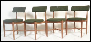 A set of four teak G-plan dining chairs designed by Koford Larsen. Raised on tapered turned legs