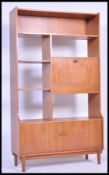 A retro 20th Century teak wood Danish inspired room divider having an arrangement of cupboards and