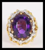 A fantastic 18ct gold large dress ring having a large central faceted amethyst with white gold