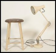 A vintage retro 20th Century Herbert Terry Anglepoise desk lamp raised on a circular base with