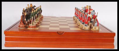 A contemporary medieval style chess set, all pieces being painted, with gilt work throughout and