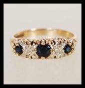 A hallmarked 9ct gold sapphire and diamond ring having alternating faceted blue stones with illusion