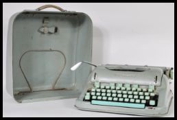A vintage mid 20th Century Paillard of Switzerland Hermes 3000 portable typewriter in enamel metal
