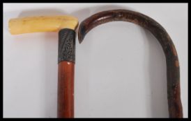 Two walking sticks to include an early 20th Century malacca walking stick having a silver collar and