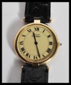 A vintage Must de Cartier wrist watch having a round face with roman numerals to the chapter ring