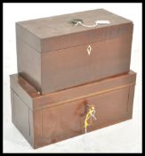 A 19th Century Georgian mahogany tea caddy having a swing handle to the top and ivory escutcheon