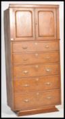 A late 19th Century Victorian walnut tall chest of five graduating drawers below twin cupboard to