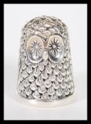 A sterling silver novelty thimble in the form of an owl. Weighs 13 grams.