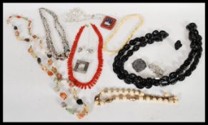 A selection of vintage costume jewellery to include a selection of beaded necklaces including