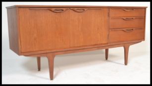 A retro 20th Century teak wood sideboard / credenza. A bank of three drawers to the left, two