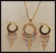 A demi parure set of earrings and a pendant necklace to include a pair of stamped 375 9ct gold
