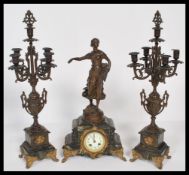 An early 20th century French bronzed spelter and marble 3 piece clock garniture set. The clock
