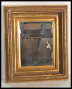 A 20th Century bevelled glass overmantel wall mirr