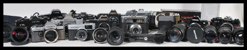 A collection of film photographic equipment to include film cameras and lenses to include a Pentax