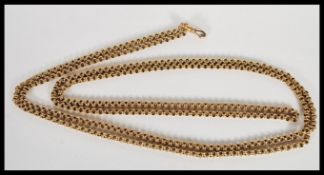 A stamped 15ct gold fob pocket watch chain of long proportions having a clip clasp. Weight 35.5g.