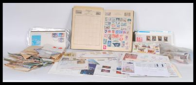 A collection of stamps from around the world contained within a stamp album together with a