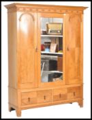 A 20th Century 1920's Edwardian oak double wardrobe having a central door with a bevelled oval