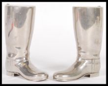 A pair of 20th Century silver plated drinks measures in the form of riding boots having raised