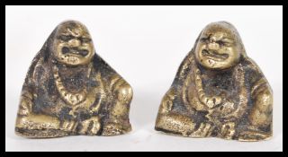 A pair of late 19th Century Chinese bronze opium weights modelled as buddhas. Standing at 2.5cm high