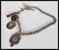 A silver hallmarked fob chain with fob medals to include a silver hallmarked fob medal with