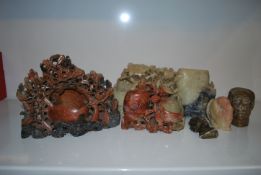 A collection of 20th Century Chinese and African soapstone carvings to include Chinese brush pots