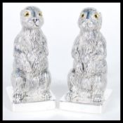 A pair of continental silver 800 stamped novelty condiments in the form of rabbits or hares raised