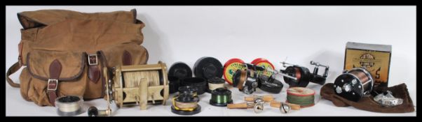 A collection of vintage fishing accessories to include reels such as a Tatler Supreme, Mitchell