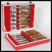A cased set of Cork & Son cutlery with stainless steel blades and stag horn handles including six