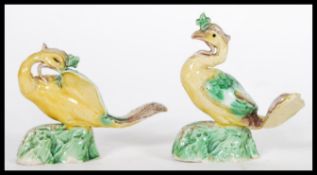A pair of 19th Century Victorian Staffordshire miniature fire side majolica figurines depicting