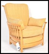 A large Ercol Renaissance light elm armchair complete with fabulous covers in very good condition,