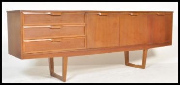 A mid century retro teak wood Danish influence sideboard credenza having tapering legs supporting