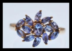 A stamped 9k 9ct gold ring set with a cluster of lilac stones. Total weight 2.3g. Size P.