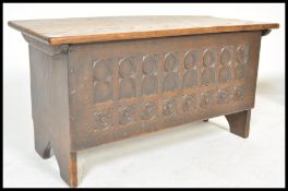 An early 19th Century oak Gothic Pugin revival chest or coffer having carved ecclesiastical  arch