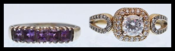 A hallmarked 9ct white gold ring set with a brilliant cut white stone with pierced shoulders